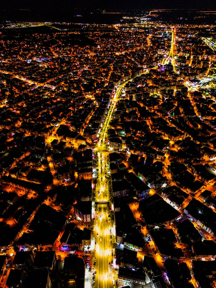 Stunning aerial view of a city illuminated at night with vibrant street lights.