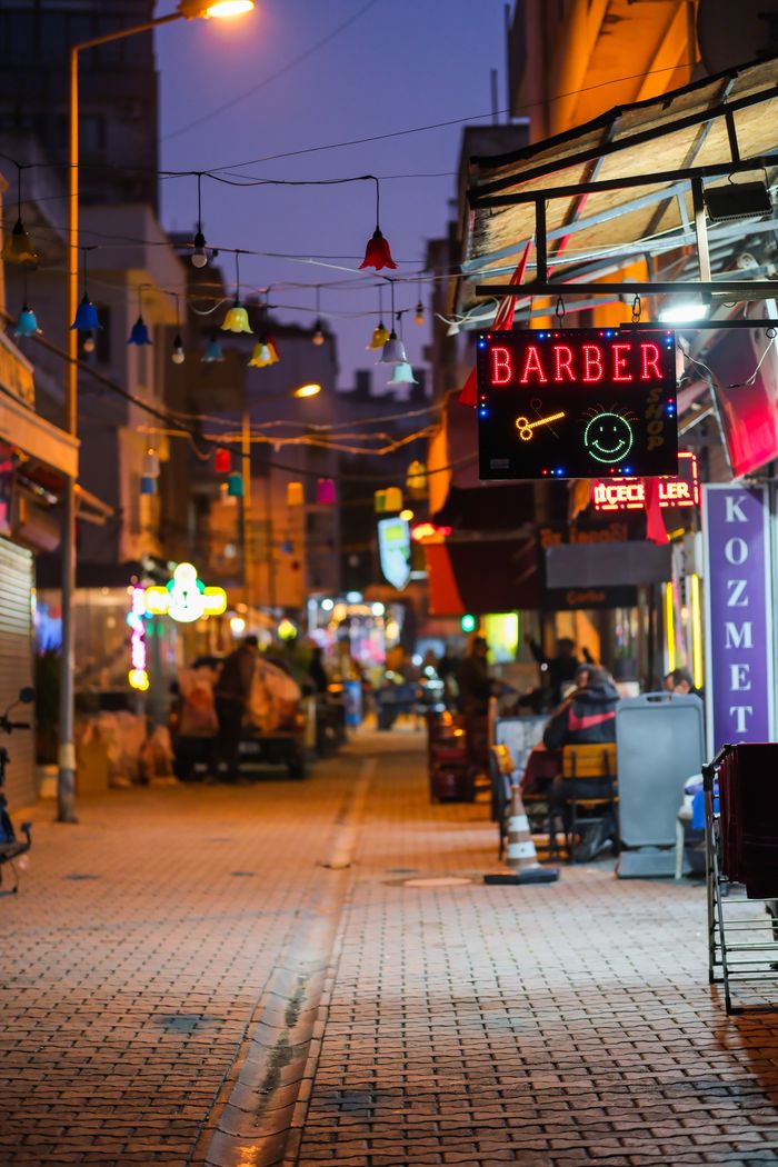 A lively night street view featuring bright neon signs and festive decorations.